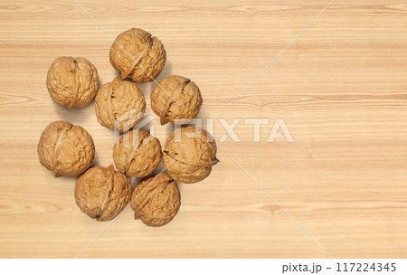 Walnuts on wooden background. Top view. Walnuts on wooden background. Top view. 117224345