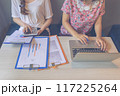 Close-up photo of women hands using laptop tablet while working 117225264