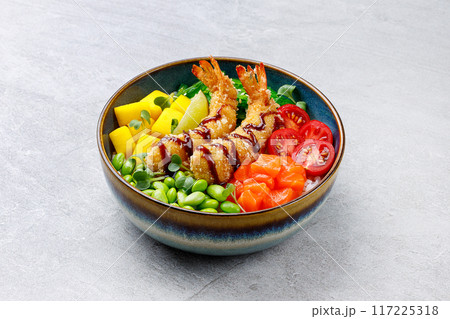 Poke bowl with salmon, shrimps and vegetables. Traditional Hawaiian raw fish salad. Top view Poke bowl with salmon, shrimps and vegetables. Traditional Hawaiian raw fish salad. Top view 117225318