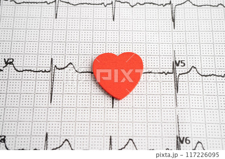 Electrocardiogram (ECG) graph paper with red heart, heart wave, heart attack, cardiogram report. 117226095