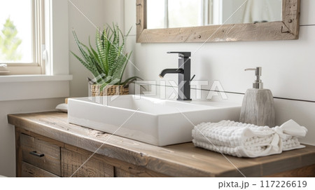 Reclaimed wood vanity with white sink in cozy bathroom, black matte fixtures, natural sunlight, neutral colors, potted plant. Bathroom white sink wooden vanity Reclaimed wood vanity with white sink in cozy bathroom, black matte fixtures, natural sunlight, neutral colors, potted plant. Bathroom white sink wooden vanity 117226619