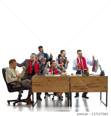 Triumphant group of men watching football match and drinking beer, shouting of joy while working at office against white studio background. 117227062