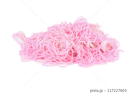 A bunch of beautiful pink beads on a fishing line over a white background. 117227603
