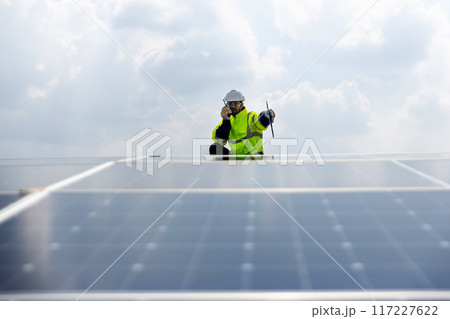 Engineer working setup Solar panel at the roof top.  117227622