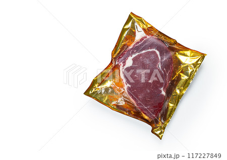 raw steak, beef steak, rib eye steak, packaged, freshly frozen, on the table, top view, white background, isolate. raw steak, beef steak, rib eye steak, packaged, freshly frozen, on the table, top view, white background, isolate. 117227849
