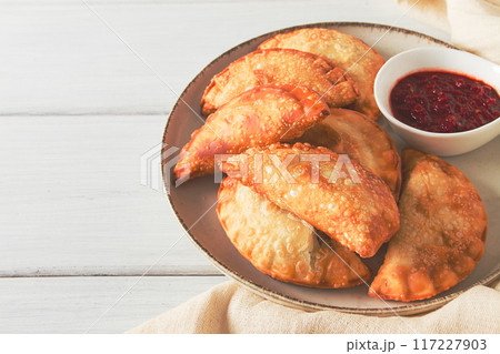 Fried chebureks, close-up, on a light background, no people, 117227903