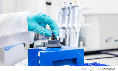 Close up of a woman shaking samples using a vortex mixer before HPLC analysis Close up of a woman shaking samples using a vortex mixer before HPLC analysis 117229852