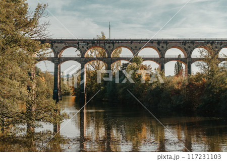 Railway Bridge with river in Bietigheim-Bissingen, Germany. Autumn. Railway viaduct over the Enz River, built in 1853 by Karl von Etzel on a sunny summer day. Bietigheim-Bissingen, Germany. Old 117231103