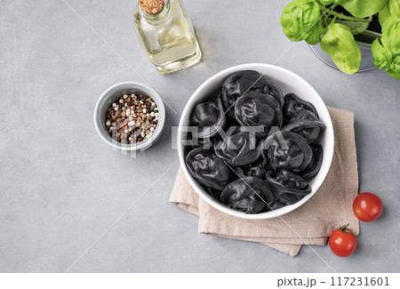 Black dumplings with meat, herbs and spices on a gray background. Russian seberian tradition food. 117231601