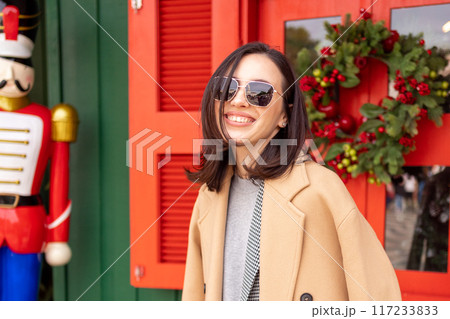 Woman walking sunny winter day European city Woman walking sunny winter day European city 117233833