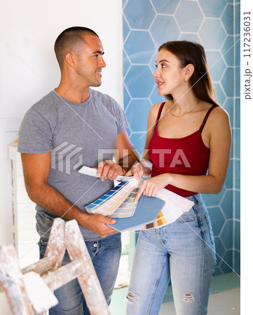 Man and woman picking color of bathroom tile at home Man and woman picking color of bathroom tile at home 117236031