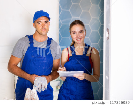 Man and woman in overalls in apartment during home improvement works 117236089
