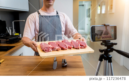 The chef is broadcasting live from workshop how to prepare a beef steaks on the electric grill The chef is broadcasting live from workshop how to prepare a beef steaks on the electric grill 117236478