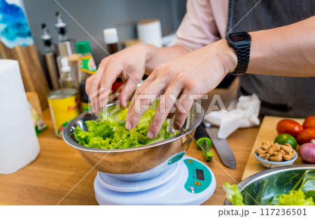 Chef at the kitchen preparing spicy glass noodle salad Chef at the kitchen preparing spicy glass noodle salad 117236501
