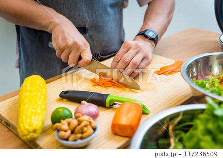 Chef at the kitchen preparing spicy glass noodle salad 117236509