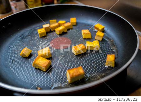 Chef at the kitchen preparing pumpkin porridge with tofu and vegetables 117236522