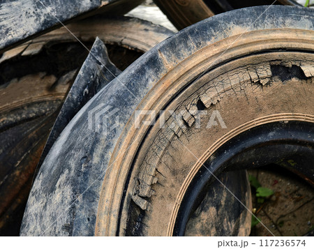 A stack of used tires is placed one on top of the other 117236574