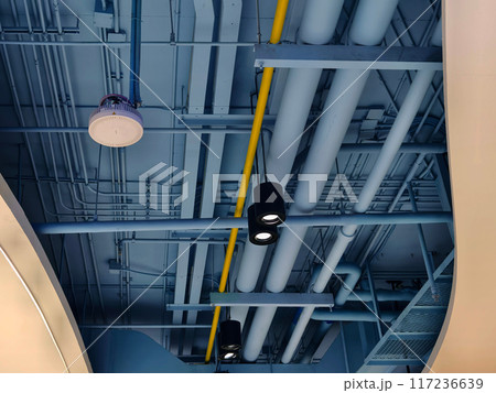Ceiling with pipes and lights in creates industrial a pattern 117236639