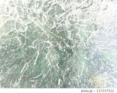 Ice texture background. Textured cold frosty surface of ice block with frozen air bubbles. Ice texture background. Textured cold frosty surface of ice block with frozen air bubbles. 117237522