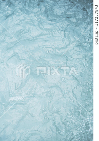 Turbulent water surface with visible foam and ripples. 117237943