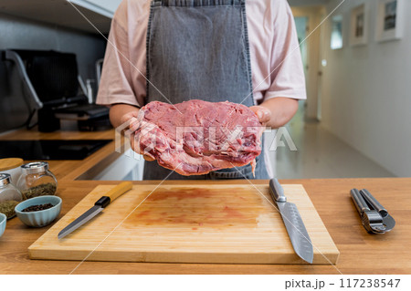 Raw fillet beef meat for steaks on the home electric grill Raw fillet beef meat for steaks on the home electric grill 117238547