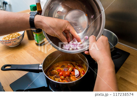 Chef at the kitchen preparing massaman curry with sweet potato and many spices Chef at the kitchen preparing massaman curry with sweet potato and many spices 117238574
