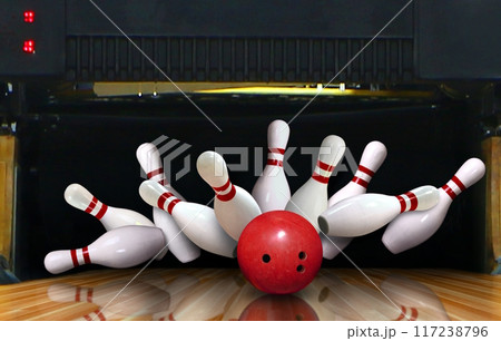 Bowling strike hit with ball hitting ten pins in the alley Bowling strike hit with ball hitting ten pins in the alley 117238796