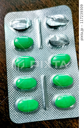 Medicines for fever and allergy are kept on a wooden table Medicines for fever and allergy are kept on a wooden table 117239309
