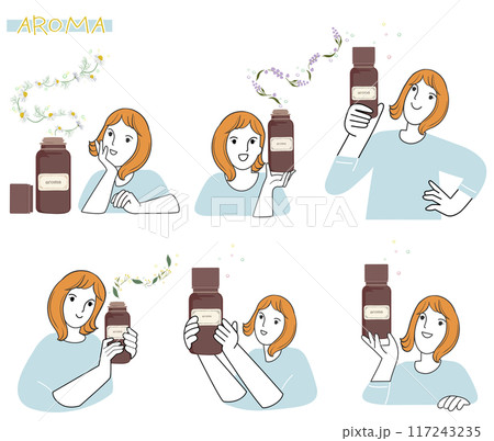 手に精油を持ってアロマの香りを楽しむ女性 117243235