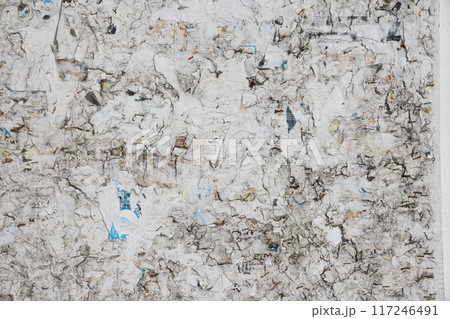 Plywood ad board with leftover scraps of paper. 117246491