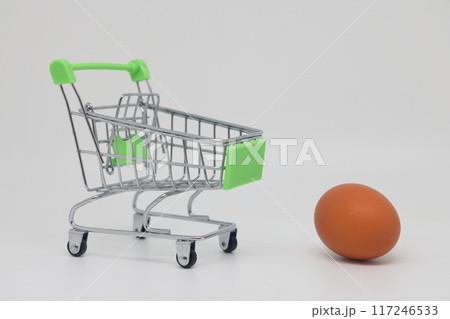 Raw egg in a grocery basket on an electronic scale. Healthy breakfast ingredient. Raw egg in a grocery basket on an electronic scale. Healthy breakfast ingredient. 117246533