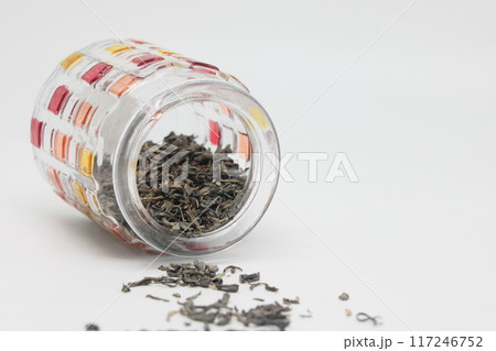 green tea and an openwork colored glass jar on a white background, a healthy drink, proper nutrition green tea and an openwork colored glass jar on a white background, a healthy drink, proper nutrition 117246752