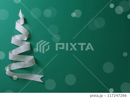 Holidays, celebrations and concept - Christmas tree. White ribbon with words Merry Christmas on green background. Template for design. Holidays, celebrations and concept - Christmas tree. White ribbon with words Merry Christmas on green background. Template for design. 117247266