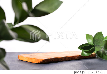 Modern product display on a gray background with branches. Wooden board podium. Modern product display on a gray background with branches. Wooden board podium. 117247330