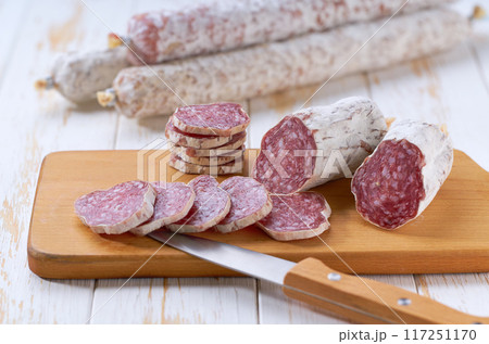 Sliced salami sausage, knife and cutting board, selective focus. Sliced salami sausage, knife and cutting board, selective focus. 117251170