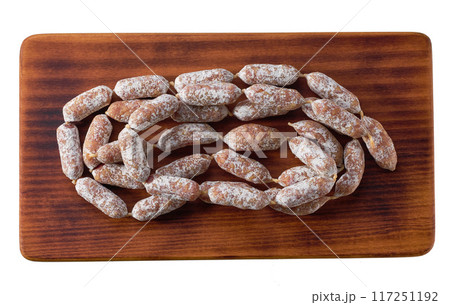 mini salami sausages on cutting board isolated on a white background, top view. 117251192