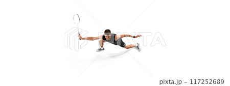 Intense training session. Top view on young man, badminton player in uniform in motion with racket, growing skills and focus isolated on white background 117252689