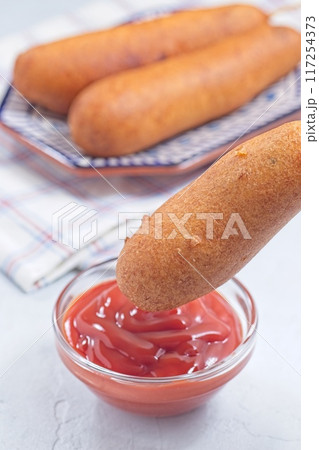 Corn dog with ketchup, vertical Corn dog with ketchup, vertical 117254373
