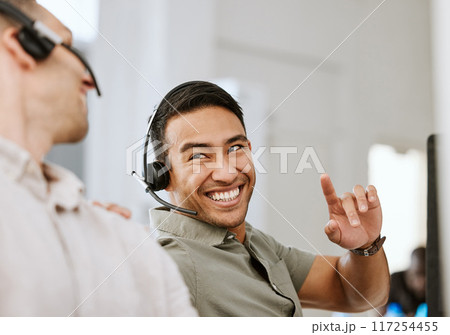 Happy, smiling and laughing call center agent at an insurance company talking to colleague at a help desk. Contact us and our sales customer service support centre and learn about us and thank you Happy, smiling and laughing call center agent at an insurance company talking to colleague at a help desk. Contact us and our sales customer service support centre and learn about us and thank you 117254455