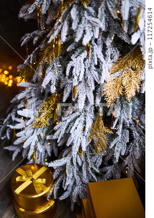 Close up of decorated Christmas tree with golden baubles and ornaments. Shallow Depth of Field 117254614