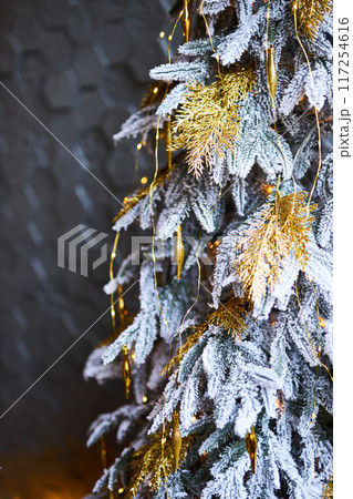 Close up of decorated Christmas tree with golden baubles and ornaments. Shallow Depth of Field 117254616