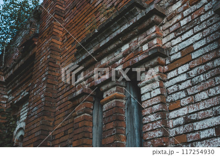 Vertical windows in an old brick building 117254930