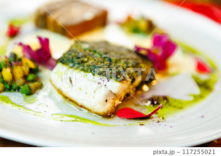 Pike-perch fillet. Potato gratin, warm yellow beet-turkey bean salad, parmesan dressing. Delicious seafood fish closeup served on a table for lunch in modern cuisine gourmet restaurant Pike-perch fillet. Potato gratin, warm yellow beet-turkey bean salad, parmesan dressing. Delicious seafood fish closeup served on a table for lunch in modern cuisine gourmet restaurant 117255021
