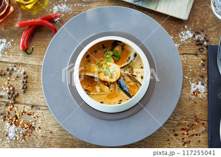 Shrimp Bisque with Seafood. King prawn, blue mussels, cod, whipped cream. Delicious traditional food closeup served for lunch in modern gourmet cuisine restaurant 117255041