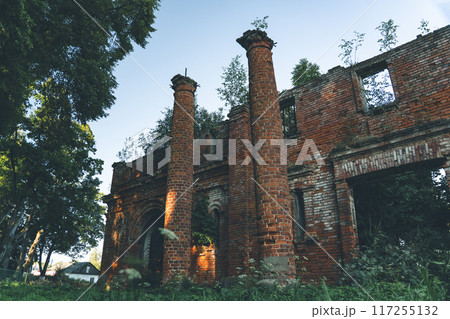Two old, dilapidated, brick columns, at the entrance to the stable 117255132