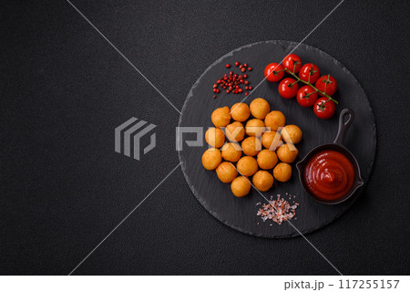 Cheese or potato balls breaded with salt, spices and herbs 117255157