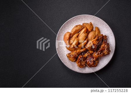Delicious crispy baked chicken wings in teriyaki sauce Delicious crispy baked chicken wings in teriyaki sauce 117255228