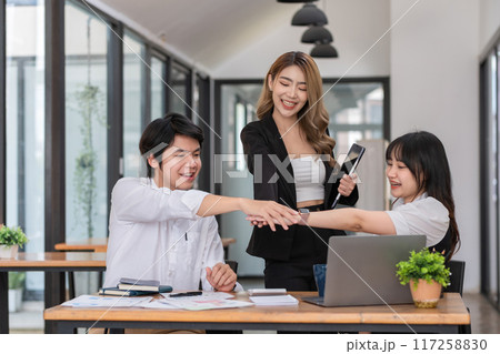 A happy business team celebrates together after receiving good news of business success. A happy business team celebrates together after receiving good news of business success. 117258830
