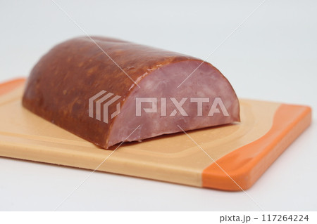 sliced boiled sausage in vacuum packaging isolated on white background. 117264224
