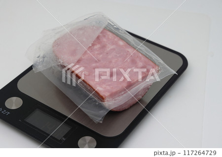 Sliced boiled delicious sausage on electronic scales, calorie counting, proper nutrition. 117264729